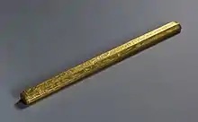  Long wooden rod covered in gold leaf and hieroglyphic inscriptions