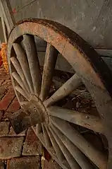 An iron-tyred wooden-spoked cart wheel