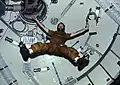 Carr floats with limbs outstretched to show the effects of zero-G.
