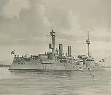 A large gray warship with two tall masts and two thin smoke stacks sits motionless offshore