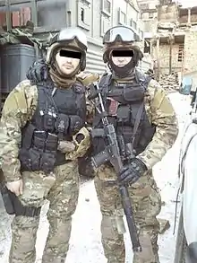 Two operators of the SOBR special police force wearing MultiCam fatigues.