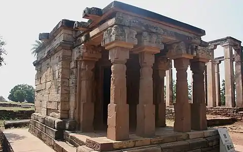 Tetrastyle prostyle Gupta period Temple 17 at Sanchi, possibly built for Buddhist use, but typical of the evolving Hindu temple.  Mauryan Buddhist apsidal hall behind.