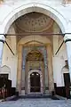 The main entrance portal with an islamic arch before entering, and intricately carved muqarnas on the portal and on the dome pendentives above.