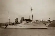 A sepia-toned image of a very large yacht.