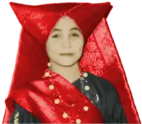 A woman wears a Minang tengkuluk tanduk horned head-dress.