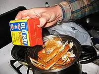 Putting Old Bay on crab legs