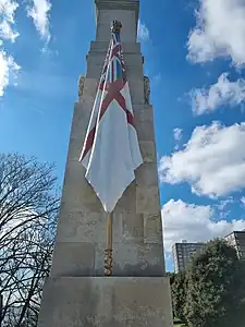 Flag carved from stone and painted as the White Ensign (a red cross on a white background with the Union Flag in the top right quadrant)