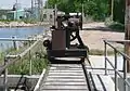 Rail-mounted winch atop diversion dam