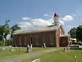St. Alphonsus Catholic Church; the monument is in front of the church in this picture