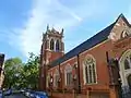 St Dionis, Parsons Green, London, 1884–85 by Ewan Christian, tower completed 1896, showing the north aisle and north-east tower, the church is in the Perpendicular Gothic style - less typical of Christian