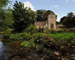 A stone church seen from the River Leach