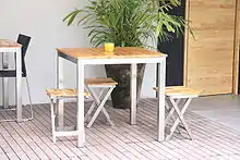 A modern Brazilian stainless steel table made with FSC-certified eucalyptus
