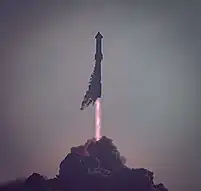 ship 24 & booster 7 rising from a dark cloud