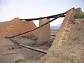 The remaining steel joists and abutments of a bridge near Midelt on the former 600&nbsp;mm (.mw-parser-output .frac{white-space:nowrap}.mw-parser-output .frac .num,.mw-parser-output .frac .den{font-size:80%;line-height:0;vertical-align:super}.mw-parser-output .frac .den{vertical-align:sub}.mw-parser-output .sr-only{border:0;clip:rect(0,0,0,0);clip-path:polygon(0px 0px,0px 0px,0px 0px);height:1px;margin:-1px;overflow:hidden;padding:0;position:absolute;width:1px}1&nbsp;ft&nbsp;11+5⁄8&nbsp;in) gauge railway.