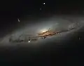 NGC 4845's glowing centre hosts a gigantic version of a black hole.