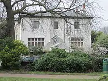 Early Victorian house seen from a park.