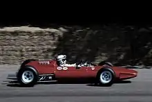 John Surtees drives a Ferrari 158 at Goodwood