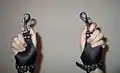 Wrists encased in suspension cuffs.
