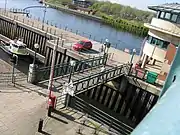 Bascule lifting bridge over the waters of the entrance to the barrage lock.