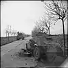 Sherman tanks passing a disabled German armoured car