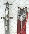Talwar hilt without knuckle bow, with extensive silver koftgari decoration.
