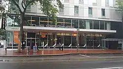 Photograph of a street level restaurant with many windows