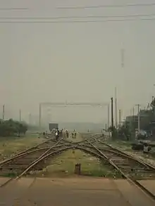 an X-shaped interception of railroads with a repair crew carrying out maintenance