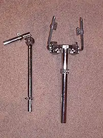 Tom arms with memory: a standard 7/8" arm (left) and a Tama twin speedball bracket (right)