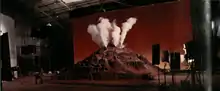 A miniature recreation of a Martian mountain with vapor rising from the top