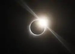 Diamond ring effect visible during the total solar eclipse of August 21, 2017, in Ravenna, Nebraska. (The diffraction spikes emanating tangentially from the diamond are an artifact of the camera optics, not a natural phenomenon.)