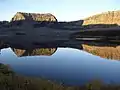 A September sunrise highlights the basalt cliffs above Trappers Lake.