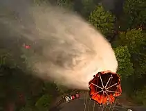 U.S. Airmen with the 129th Rescue Wing, California Air National Guard drop water on the Rim Fire near Yosemite, CA, Aug. 26, 2013