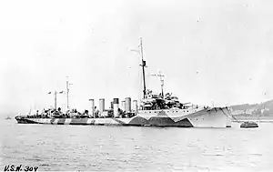 USS Cassin (DD-43) moored alongside another U.S. Navy destroyer, at Queenstown, Ireland, circa 1918. She is painted in "Dazzle" type camouflage.