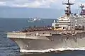 USS Saipan (LHA-2), with USS Mount Whitney (LCC-20) in the background