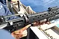 Navy sailor loading an M203 with a high explosive round