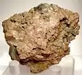 Two sharp, brown, octahedral uraninite crystals on red-brown orthoclase matrix, from Bancroft
