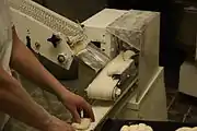 6. The conveyor belt transports the pressed dough