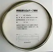 .mw-parser-output .template-chem2-su{display:inline-block;font-size:80%;line-height:1;vertical-align:-0.35em}.mw-parser-output .template-chem2-su>span{display:block;text-align:left}.mw-parser-output sub.template-chem2-sub{font-size:80%;vertical-align:-0.35em}.mw-parser-output sup.template-chem2-sup{font-size:80%;vertical-align:0.65em}V3Ga superconducting tape (10&nbsp;mm × 0.14&nbsp;mm cross section). A vanadium core is covered with 15&nbsp;μm .mw-parser-output .template-chem2-su{display:inline-block;font-size:80%;line-height:1;vertical-align:-0.35em}.mw-parser-output .template-chem2-su>span{display:block;text-align:left}.mw-parser-output sub.template-chem2-sub{font-size:80%;vertical-align:-0.35em}.mw-parser-output sup.template-chem2-sup{font-size:80%;vertical-align:0.65em}V3Ga layer, then 20&nbsp;μm bronze (stabilizing layer) and 15&nbsp;μm insulating layer. Critical current 180&nbsp;A (19.2&nbsp;T, 4.2&nbsp;K), critical current density 20&nbsp;kA/cm2.