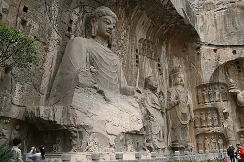 Tang dynasty statue of Vairocana (Dàrì Rúlái) at Longmen Grottoes, Luoyang, Henan, China. The statue was completed in the year 676 and is 17.14&nbsp;m high and has 2&nbsp;m long ears.
