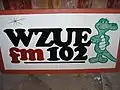 Photo of WZUE logo on a billboard, branded as "Zoo 102"
