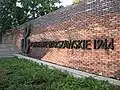 The Kotwica on the wall next to the Warsaw Uprising Monument in Krasiński Square.