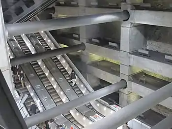Image 34Escalators at Westminster Underground station descend between beams and columns of the station box to reach the deep-level Jubilee line platforms.