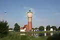 Water tower seen with the surroundings and pond