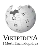 Wikipedia logo showing "Wikipedia: The Free Encyclopedia" in Vlax Romani