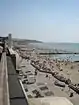 The beach crowded with people at lower tide