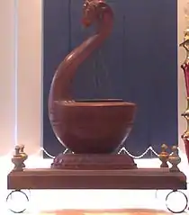Modern reproduction of a Yazh, an instrument used in Ancient Tamil music. This reproduction has a yali head carved into the curved neck.