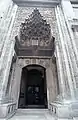 The entrance to the mosque, featuring a carved muqarnas portal