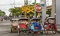 Rickshaws waiting for passengers near the statiom