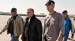 Zeev Rosenstein, escorted by federal agents, on his way from Israel to trial in the USA.