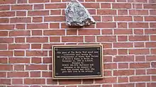 The inscription reads: "This piece of the Berlin Wall stood near Lichterfelde until broken by the sledgehammer of Mr. Rick DeLisle on November 11, 1989, at 6:50 am. Donated by WMIX 106.5 FM Baltimore and dedicated to those who crossed and those who gave their lives in the attempt."